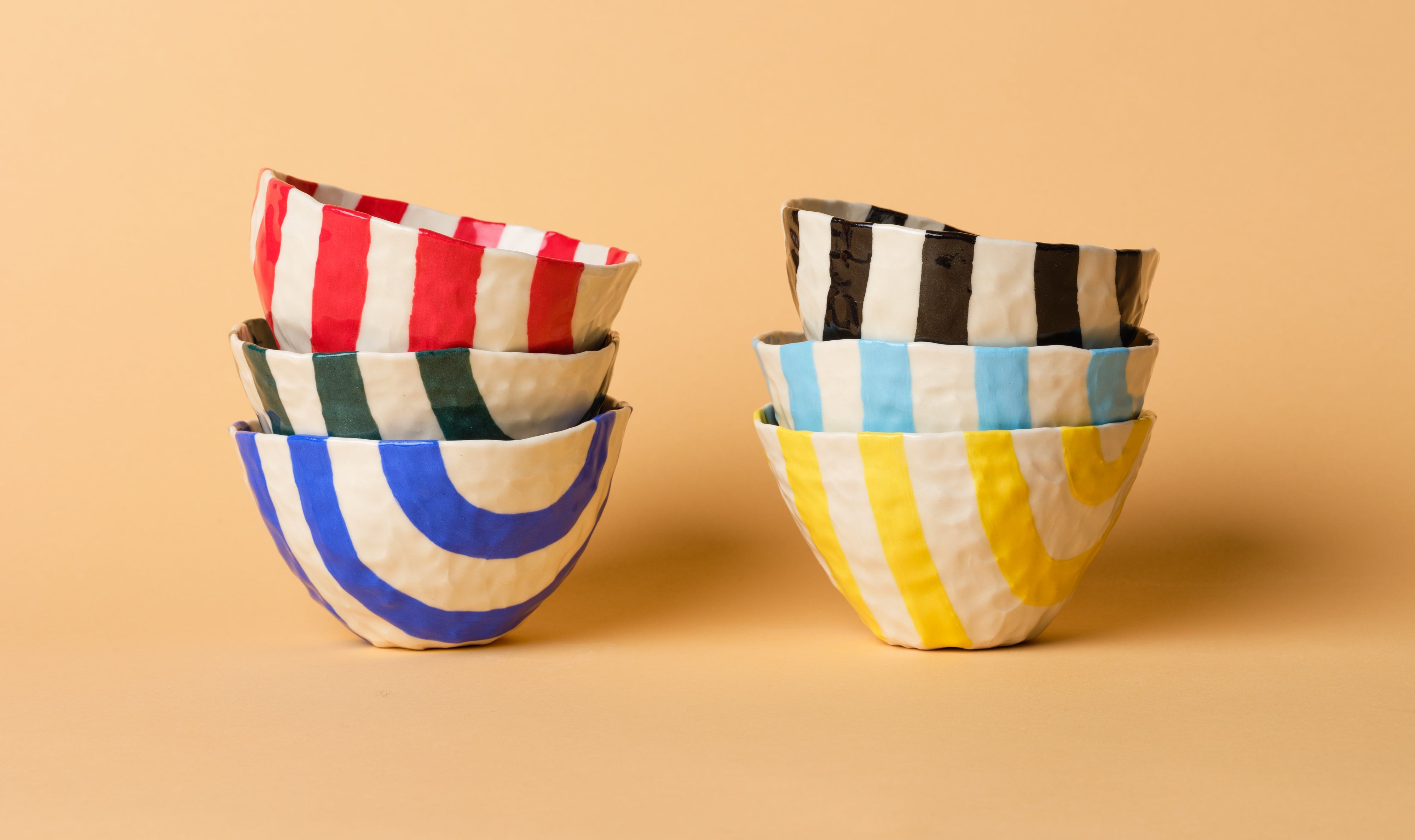 Set of colorful ceramic bowls on a beige background